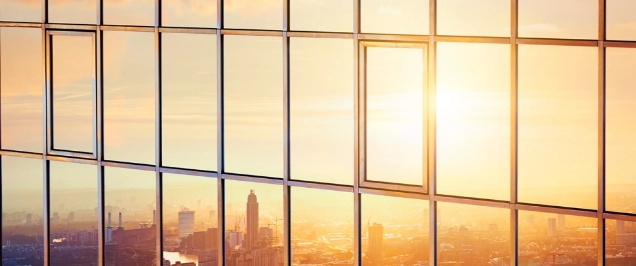 Image of city in the reflection of a glass building
